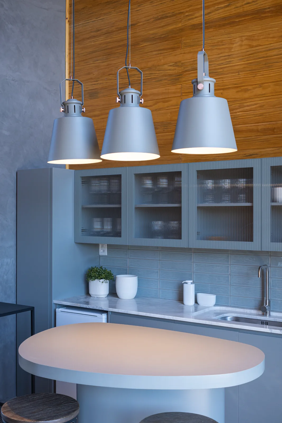 Pendant lights above a residential kitchen island